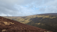 A brown slope in the foreground, with a steep, flat-topped hill beyond. headwaters of Allt Scheicheachan
