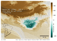 A pseduo-colour terrain map of Laguna del Carbón. Low elevations are shown in progressively darker teal colors, higher elevations in darker browns. The color scale pivots at 0 m a.s.l which is white. This shows that the lowest point is _below_ sea level. The title text reads: 'Laguna del Carbón: -105m, gran bajon de san julian, argentina'. n the bottom left is an inset map showing the outline of South America, with an arrow pointing to southern Argentina