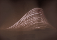 A monochrome solarigraph showing a series of stacked arcs - the sun's path over the course of 6 months - on the left the point at which the sun rises varies, the arcs are truncated a bit after their peaks in mid-afternoon.